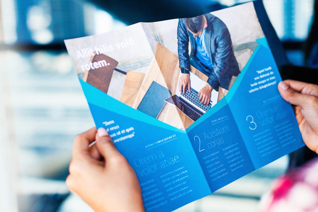 hands-holding-business-brochure-scaled